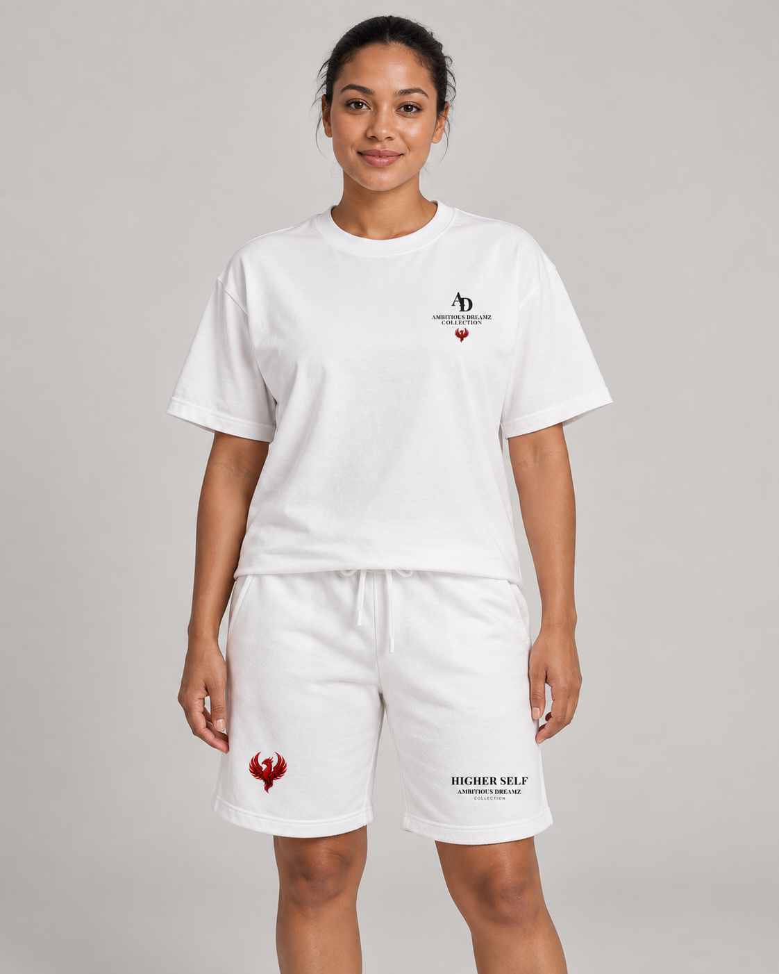 AI model mockup showing the Ambitious Dreamz white boxy tee and Higher Self shorts, front view. Pieces sold separately.